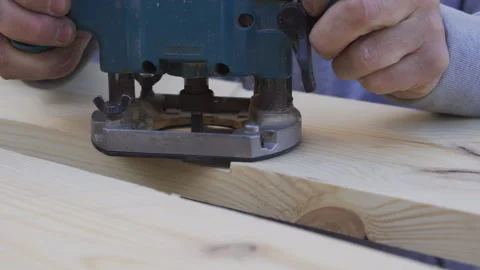A man processes a board using a router. Carpentry work. Hands close-up Stock Footage 253507398