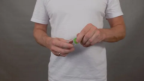 Man processes his hands with a sanitizer, pours from a can on his hand and rubs Stock Footage 128138440