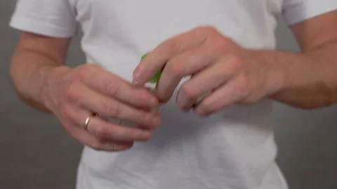 Man processes his hands with a sanitizer, pours from a can on his hand and rubs Stock Footage 128138522