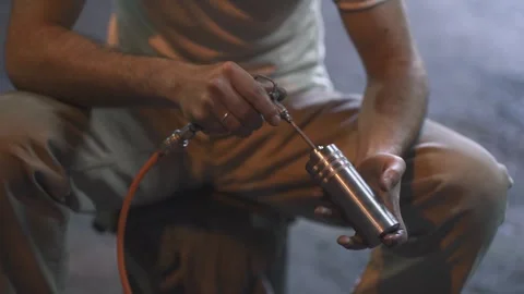 A man processes a metal product with a tool Stock Footage 288485358