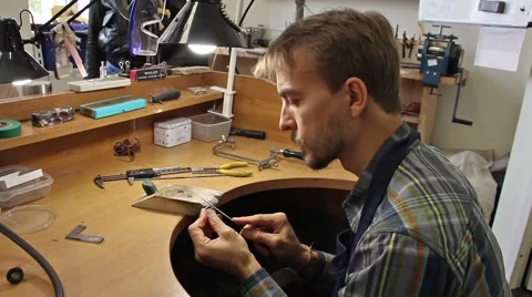 Man processes the surface of the billets for silver ring with a file(tool) Video stock 56581121