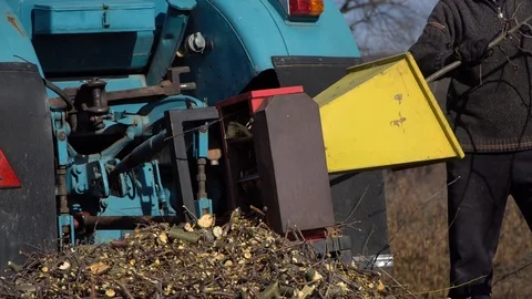 A man processes wood  with shredder.Device chopping wood to chips Stock Footage 126205055