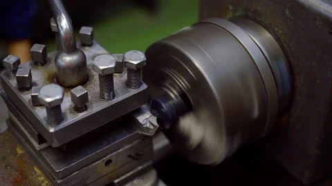 Man is processing metal details on a turning lathe in workshop, top view on Stock Footage 97408628