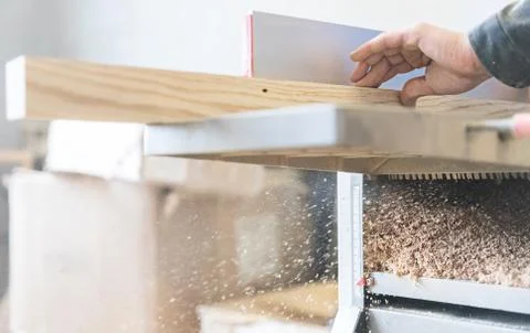 A man is processing a tree. Joiner. A carpenter. Woodworking Processes Stock Photos
