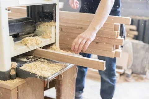 A man is processing a tree. Joiner. A carpenter. Woodworking Processes Stock Photos