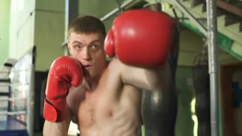 Man professional boxer does blows in shadow, steady shot, slow motion Stock Footage 116260189
