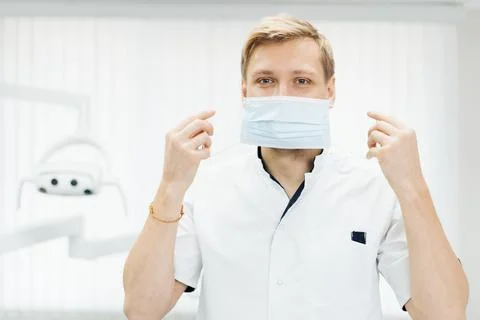 Man professional medic put on protective face mask. Stock Photos
