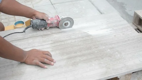 Man professional worker cutting tile with circular saw electric construction Stock Footage 114643123