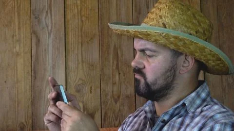 Man in profile looking at smartphone Stock Photos