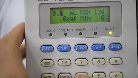 A man programes a pump used for Physicochemical  analysis of organic compounds i Stock Footage 254600517