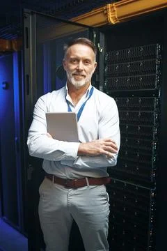Man, programmer and arms crossed with tablet in server room for research, c.. Stock-Fotos