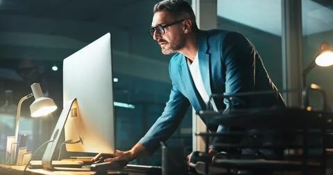 Man, programmer and office with computer at night for programming website Stock Photos