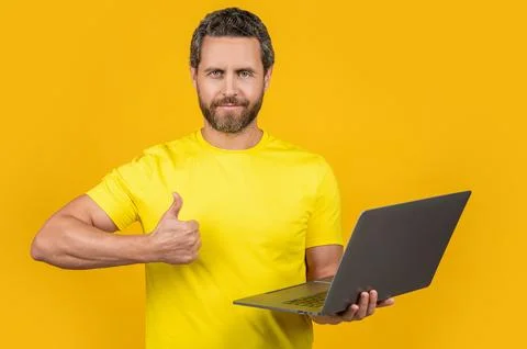 Man programmer isolated on yellow, thumb up. man programmer on background Stock Photos