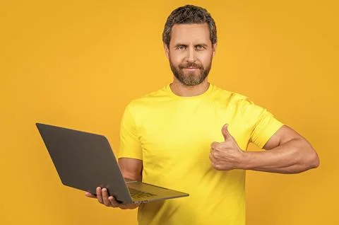 Man programmer isolated on yellow, thumb up. man programmer on background Stock Photos