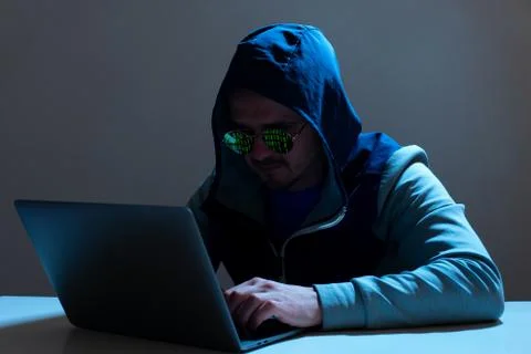 Man programmer or hacker working on laptop Stock Photos