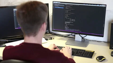 Man programmer typing on a keyboard code. back view.  Stock Footage 63421290