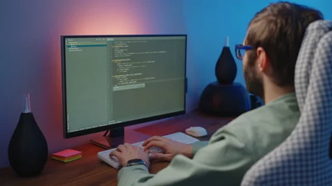 Man programmer typing on a keyboard code. back view. Focus on the screen. Stock Footage 228943321