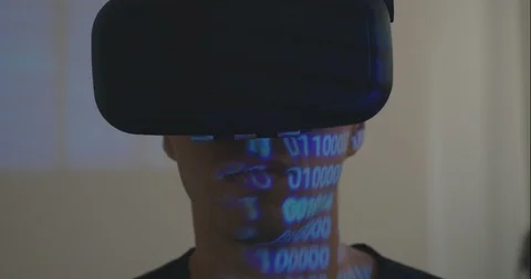 Man programmer wearing virtual reality hemlet or VR Glasses with binary code 스톡 동영상 94836326