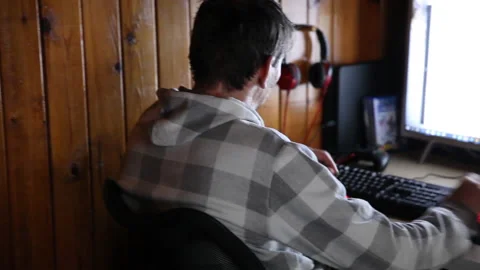Man programmer working on computer at home coding on screen writing code Stock Footage 130349700