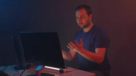 Man programmer works at a pc and faces problems while writing code. Video stock 90979614