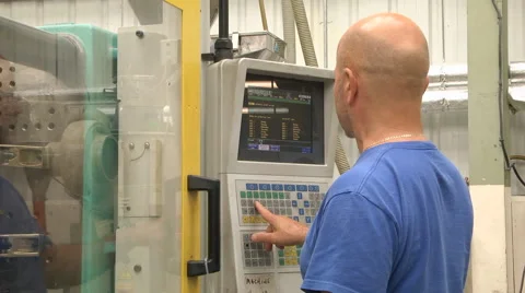 Man programming CNC controller on machinery Stock Footage 46632086