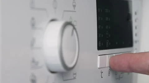 Man Programming the Function Buttons from the Front Panel of Laundry Machine. Video stock 160318692