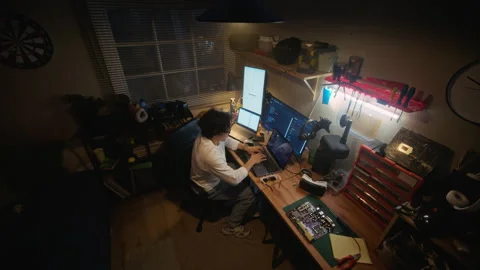 Man Programming Software on Laptop in Home Tech Workshop Stock Footage 338424759