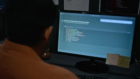 Man Programming Software Using Assistant on Computer Stock Footage 348352759