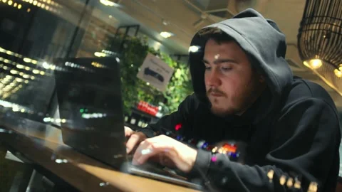 A man is programming, typing a code on a laptop at night in an institution, p Stock Footage 219819018