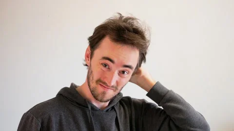 A man prone to baldness combs his hair very carefully. An unshaven and shabby Stock Footage 247610173