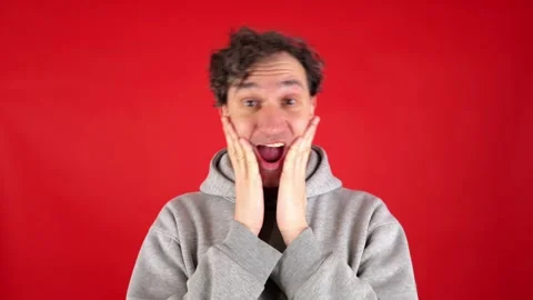 Man pronouncing word wow on studio red background Видео 304750244