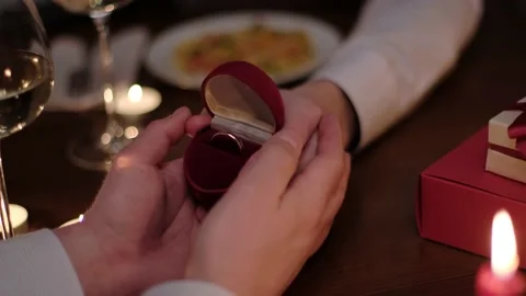 Man proposing to marry his partner holding out a ring Stock-Footage 149422308