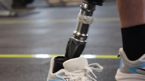 A man with a prosthesis instead of an amputated leg stands in a gym. Stock Footage 318652108