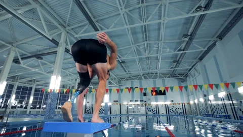 A man with a prosthesis jumps into a pool, artificial leg. Stock Footage 105001065