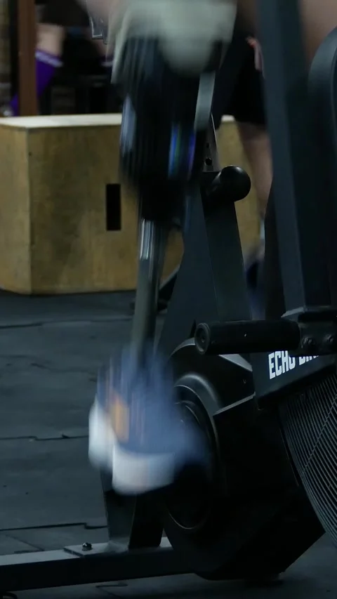 A man with a prosthesis spins a bicycle wheel instead of a leg in a gym. Stock Footage 317749652
