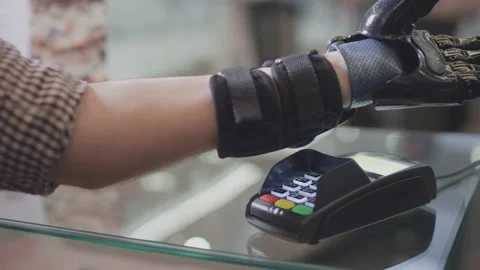 A man with a prosthetic arm uses a smartwatch. Pays for the purchase through the Stock Footage 147890656