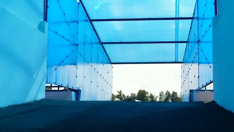 A man with a prosthetic leg is fixing a backpack while walking Stock Footage 116802457