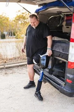 Man with prosthetic leg preparing for van life Stock Photos