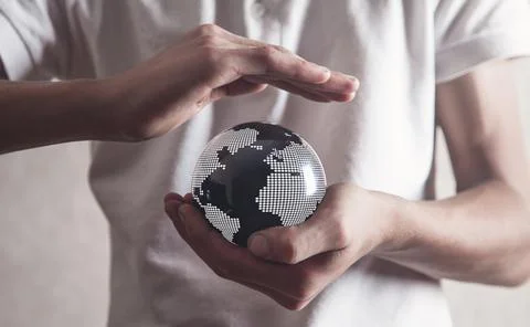 Man protect world map on black crystal ball. Stock Photos