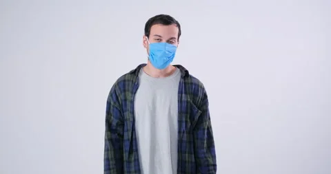 Man in protective face mask posing in camera Stockbeeldmateriaal 143943867