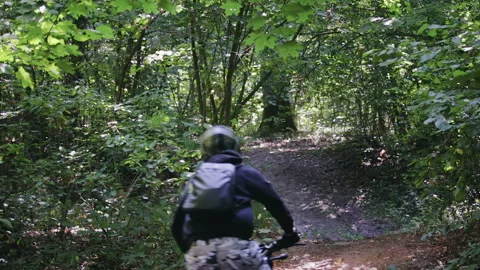 Man in protective gear with a helmet rides extremely black Enduro on a forest 動画素材 115883529