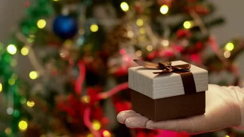 Man in protective gloves giving Christmas present to a woman Stock Footage 166317406