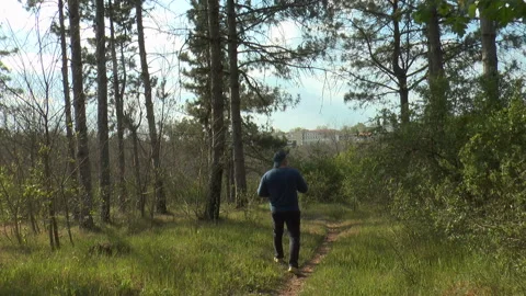 A man in a protective mask and gloves in the forest takes pictures of nature 스톡 동영상 129758871