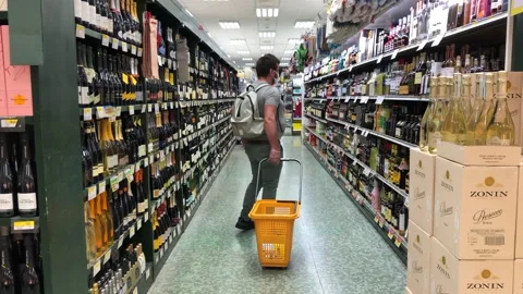 Man in a protective mask choosing alcohol Stock Footage 130248651