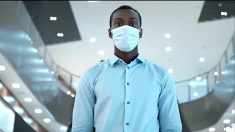 A man in a protective mask during an epidemic remains in touch on the Internet Stock Footage 138212965