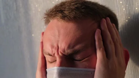 Man in protective mask with headache, close-up Stock Footage 156330136