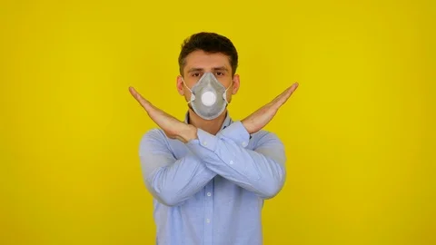 Man in protective mask looks at camera and keeps his arms crossed Stock Footage 124906000