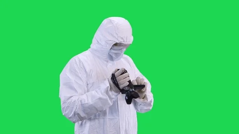 A man in a protective suit and goggles carefully selects the shooting mode in Stock Footage 128925786