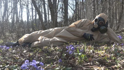 Man in protective suit, mask in forest Stock Footage 130975253