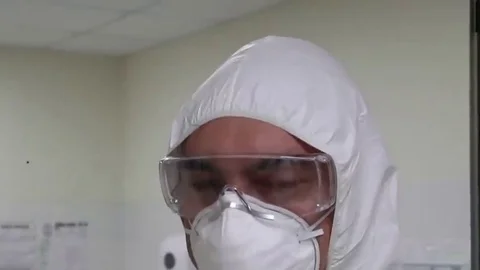 A man in a protective suit. Protective mask. Quarantine Stock Footage 128545752